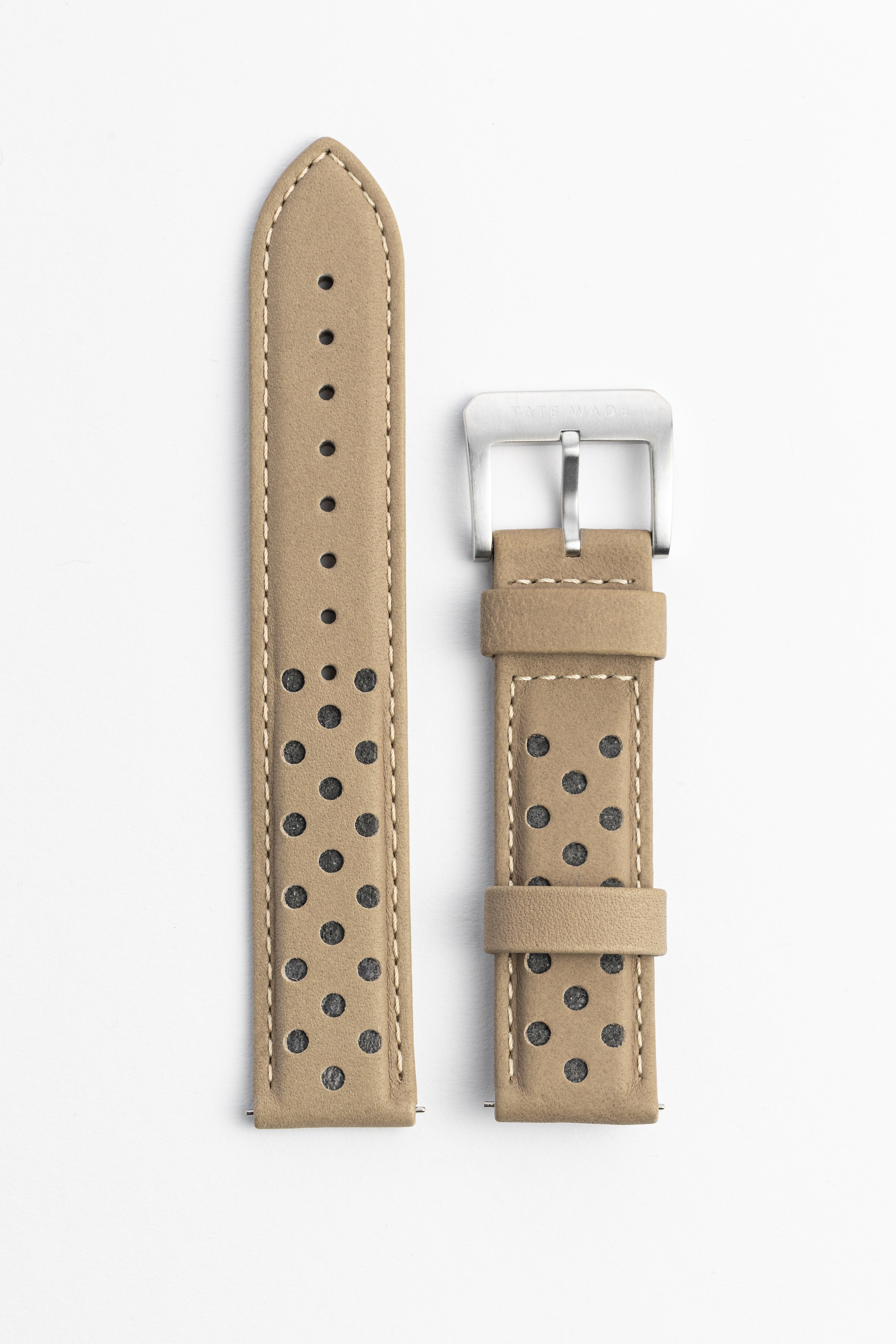 Beige watch strap with black perforations on a white background