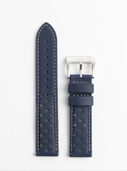 Navy blue watch strap with white stitching on a light gray background
