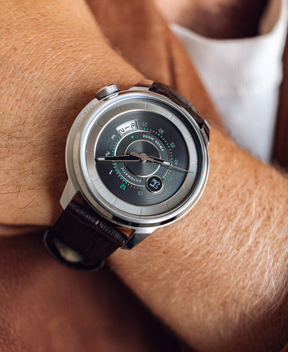 Close-up of a wrist wearing a Tate Wade Stainless Steel with a brown leather strap.